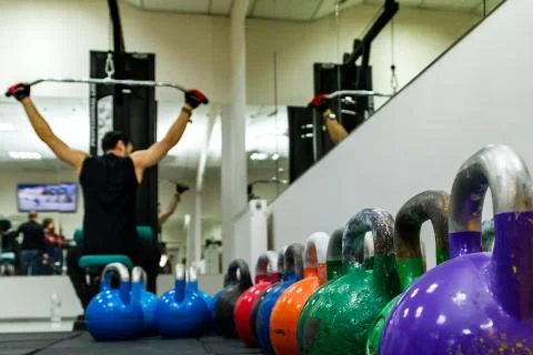Colored kettlebels on a rubber mat Stock Photos
