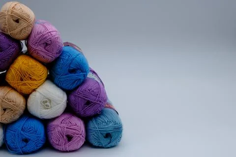 Colored knitting threads on a gray background Stock Photos