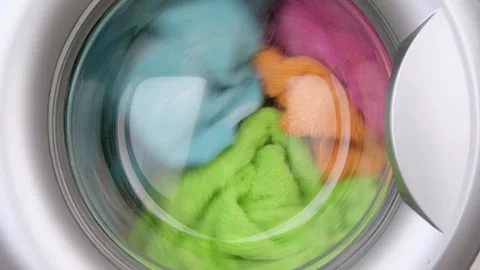 Colored laundry is washed in the washing machine Video stock 310315956