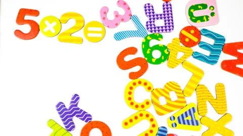 Colored letters amalgam in white background, top view, copy space Stock Photos