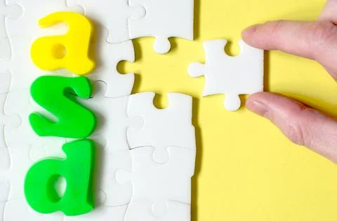 Colored letters ASD on a background of white puzzles Stock Photos