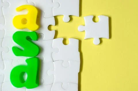 Colored letters ASD on a background of white puzzles Stock Photos