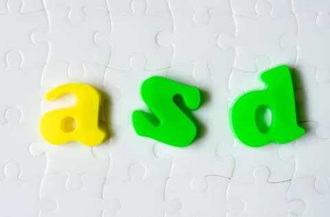 Colored letters ASD on a background of white puzzles Stock Photos