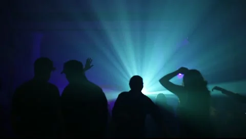 Colored Lights and Background People Silhouetted at Party Vídeos de archivo 10754453