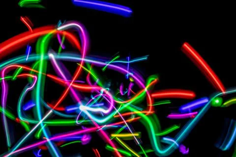 Colored lights on a neutral black background forming an abstract pattern. 写真素材