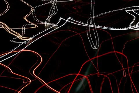Colored lines of lights on a black background Stock Photos