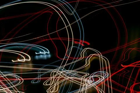 Colored lines of lights on a black background Stock Photos