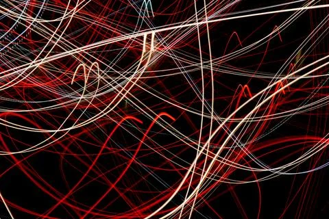 Colored lines of lights on a black background Stock Photos