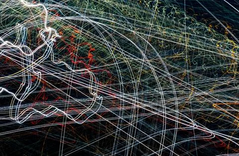 Colored lines of lights on a black background Stock Photos
