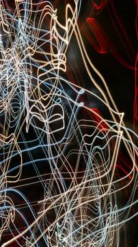 Colored lines of lights on a black background Stock Photos