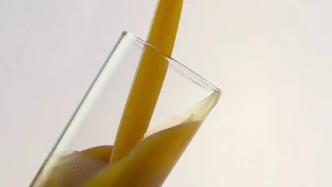 Colored liquid pouring in to the glass Stock Footage 75814067