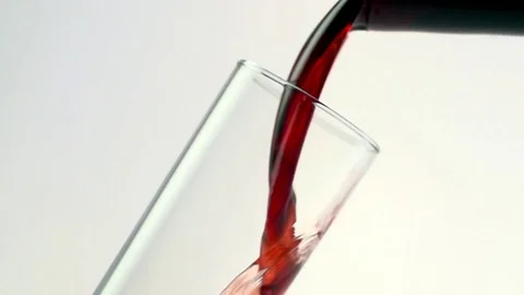 Colored liquid pouring in to the glass Stock Footage 75814068