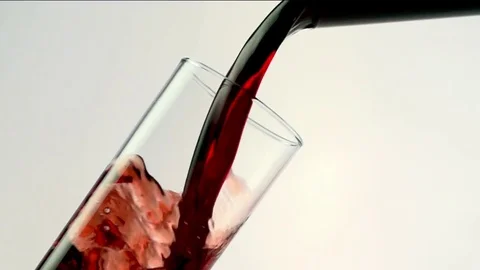 Colored liquid pouring in to the glass Stock Footage 75814075