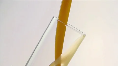 Colored liquid pouring in to the glass Stock Footage 75814078
