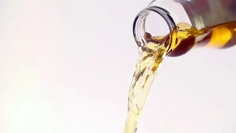 Colored liquid pouring in to the glass Stock Footage 76433035