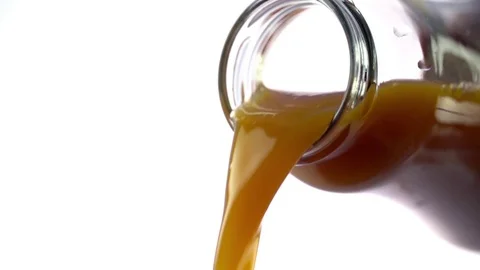 Colored liquid pouring in to the glass Stock Footage 76433065