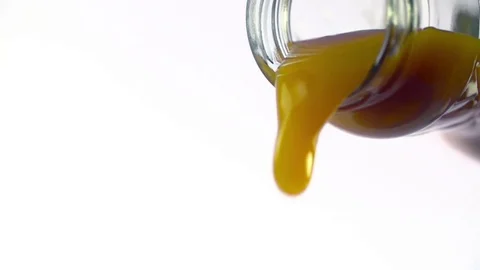 Colored liquid pouring in to the glass Stock Footage 76433066