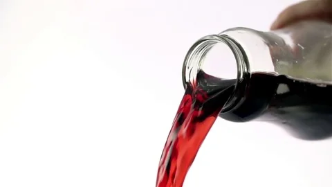 Colored liquid pouring in to the glass Stock Footage 76433081