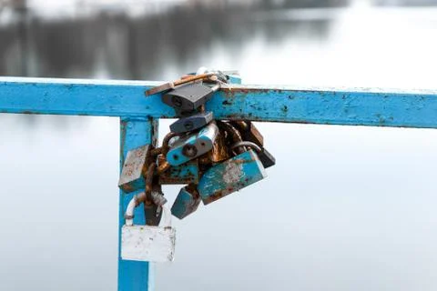 Colored Locks on the Bridge Over the River Stock Photos