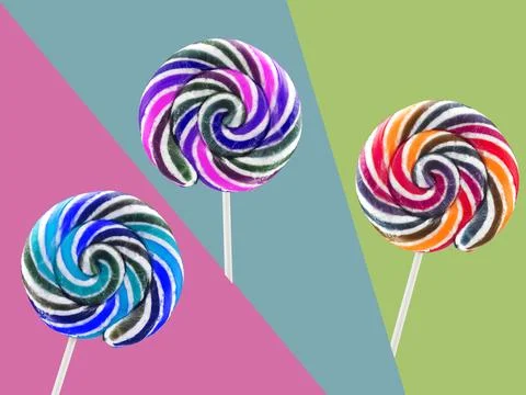 Colored lollipops on bright colored background Stock Photos