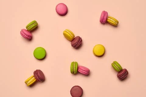 Colored macaron or macaroon, sweet meringue-based confection on pink background Fotos Stock