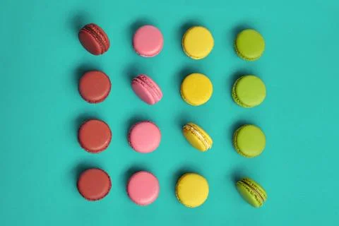 Colored macaron or macaroon, sweet meringue-based confection on blue background Fotos Stock