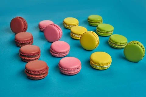 Colored macaron or macaroon, sweet meringue-based confection on blue background Fotos Stock