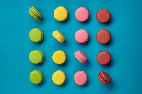 Colored macaron or macaroon, sweet meringue-based confection on blue background Fotos Stock