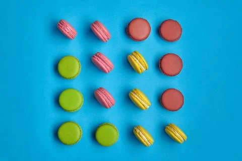 Colored macaron or macaroon, sweet meringue-based confection on blue background Fotos Stock