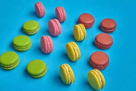 Colored macaron or macaroon, sweet meringue-based confection on blue background Fotos Stock