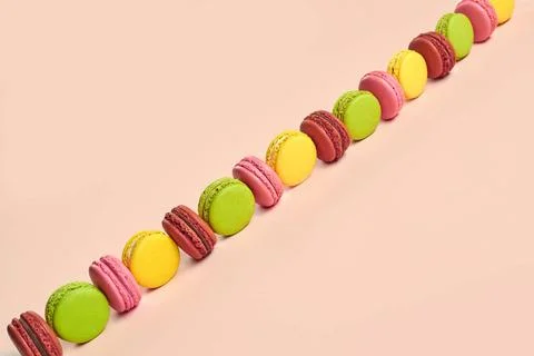 Colored macaron or macaroon, sweet meringue-based confection on pink backg... Fotos Stock