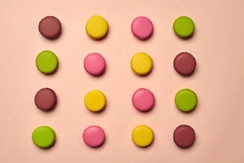 Colored macaron or macaroon, sweet meringue-based confection on pink backg... Fotos Stock