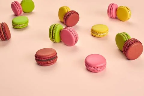 Colored macaron or macaroon, sweet meringue-based confection on pink backg... Fotos Stock
