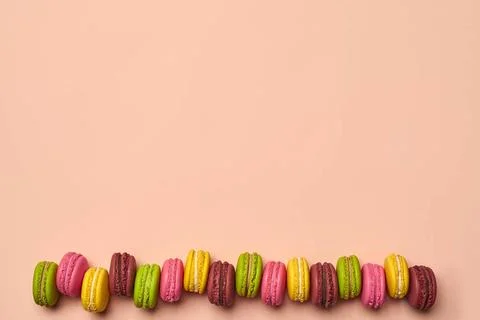 Colored macaron or macaroon, sweet meringue-based confection on pink backg... Fotos Stock