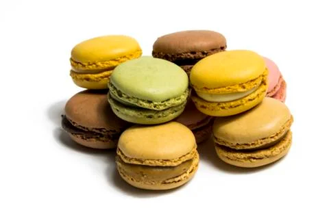 Colored macarons isolated on white background, typical French dish Stock Photos