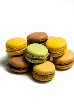 Colored macarons isolated on white background, typical French dish Stock Photos