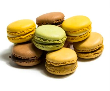 Colored macarons isolated on white background, typical French dish Stock Photos