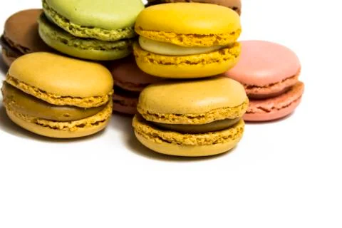 Colored macarons isolated on white background, typical French dish Stock Photos