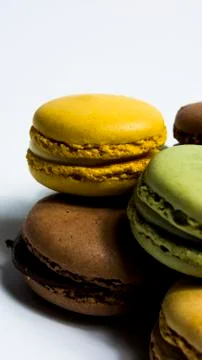 Colored macarons isolated on white background, typical French dish Stock Photos