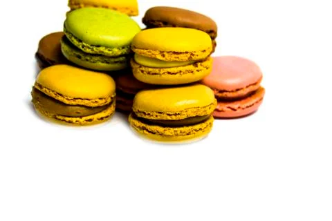 Colored macarons isolated on white background, typical French dish Stock Photos