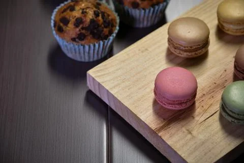 Colored macaroons with chocolate muffins Stock Photos