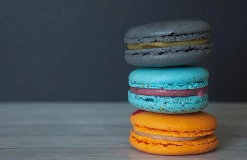 Colored macaroons on a dark background close-up, french cookies as a treat fo Stock Photos