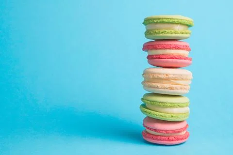 Colored macaroons row on blue background Stock-Fotos