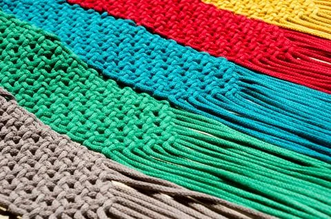 Colored macrame stripes in blue, yellow, red, beige, green and pink colors. Stock Photos