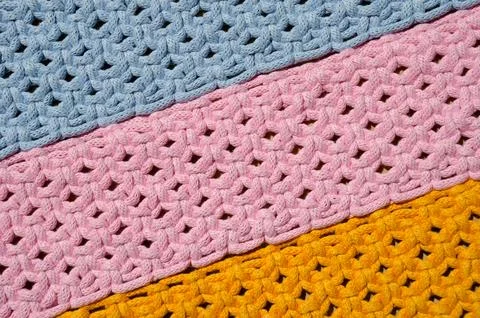 Colored macrame stripes in blue, yellow and pink colors. Stock Photos