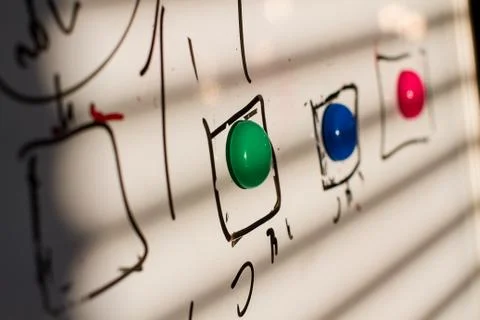 Colored magnets on the board Stock Photos