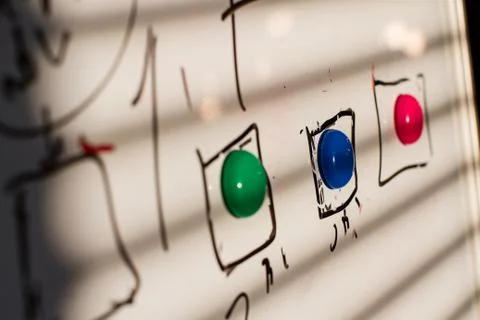 Colored magnets on the board Stock Photos