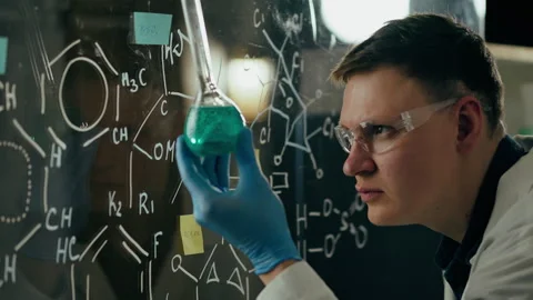 Colored marker, Laboratory worker Carefully looks at a test tube with an exp Stock Footage 246309199