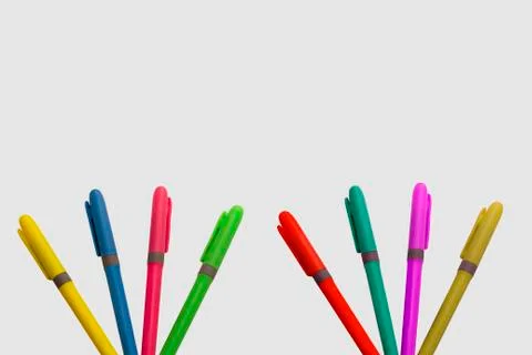 Colored markers on white background with a fun design Stock Photos