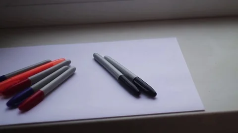 Colored markers on a white sheet Stock Footage 70899477